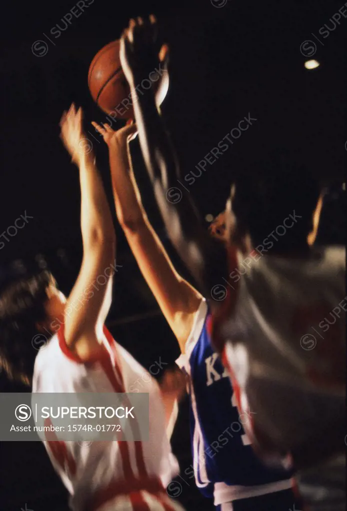 Young women reaching for a basketball