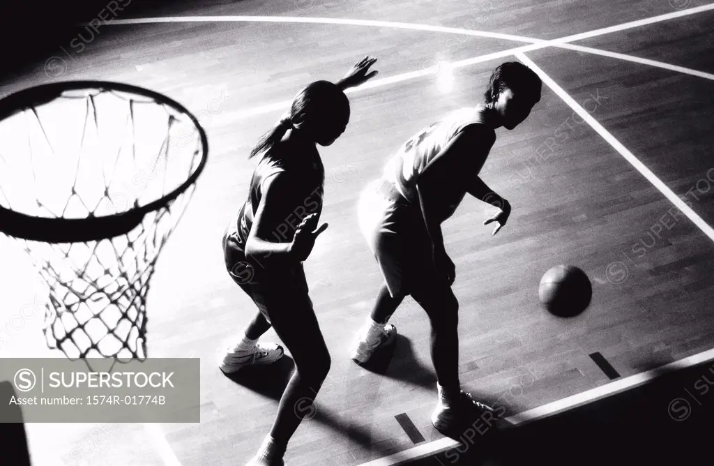 High angle view of two women playing basketball
