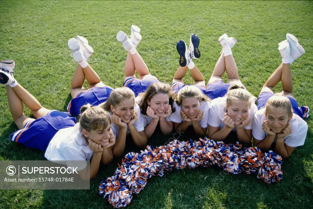 High angle view of cheerleaders lying on a lawn