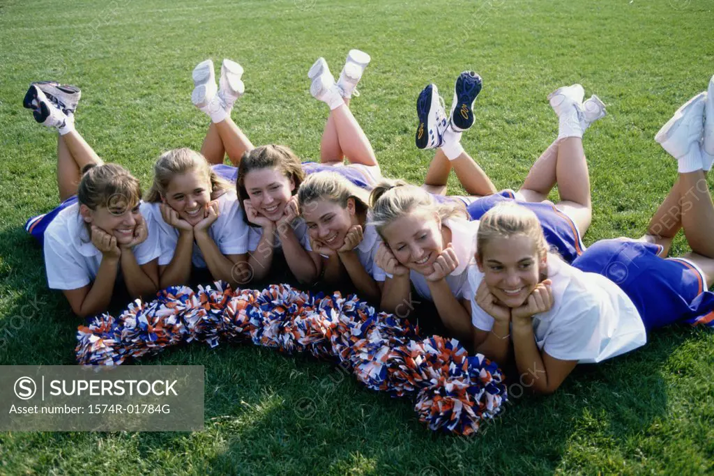 High angle view of cheerleaders lying on a lawn