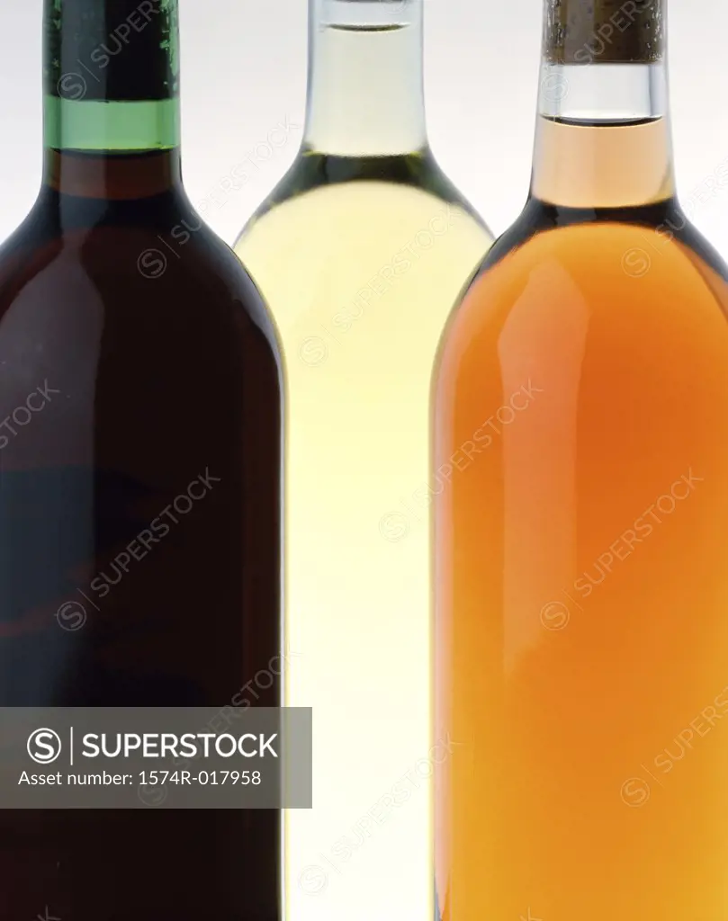 Close-up of three wine bottles