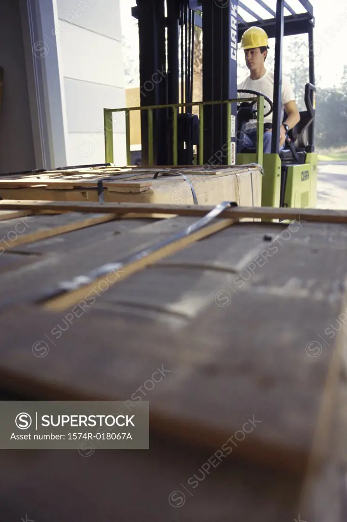 Young man sitting in a forklift