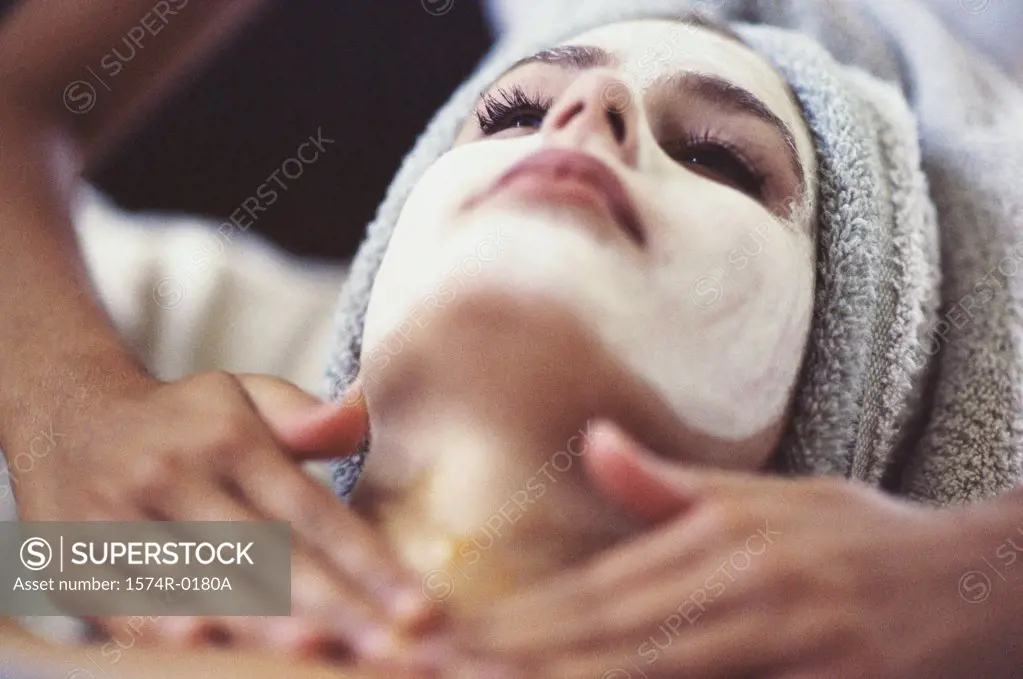 Close-up of a young woman getting a facial treatment