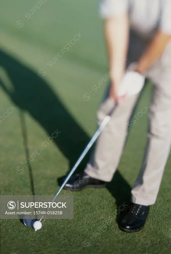 Low section view of a man playing golf