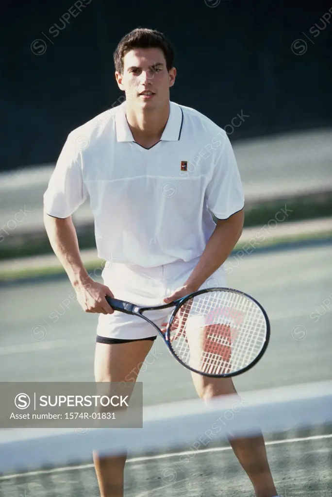 Portrait of a young man playing tennis