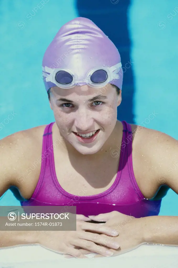 Portrait of a young woman standing in a swimming pool