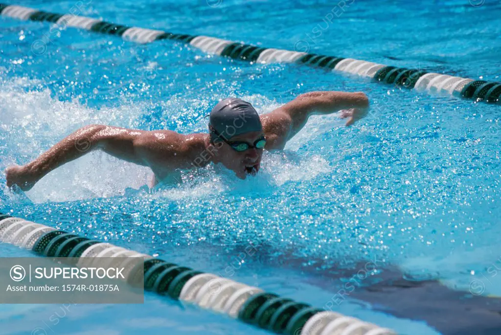 Young man swimming in a swimming pool