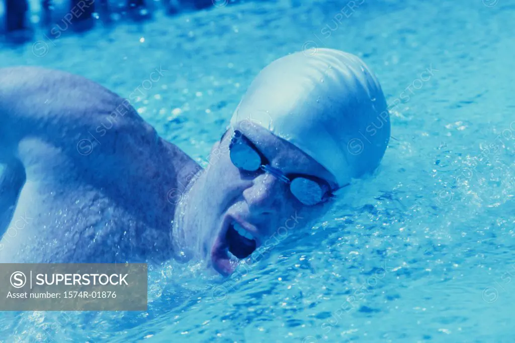 Young man swimming in a pool