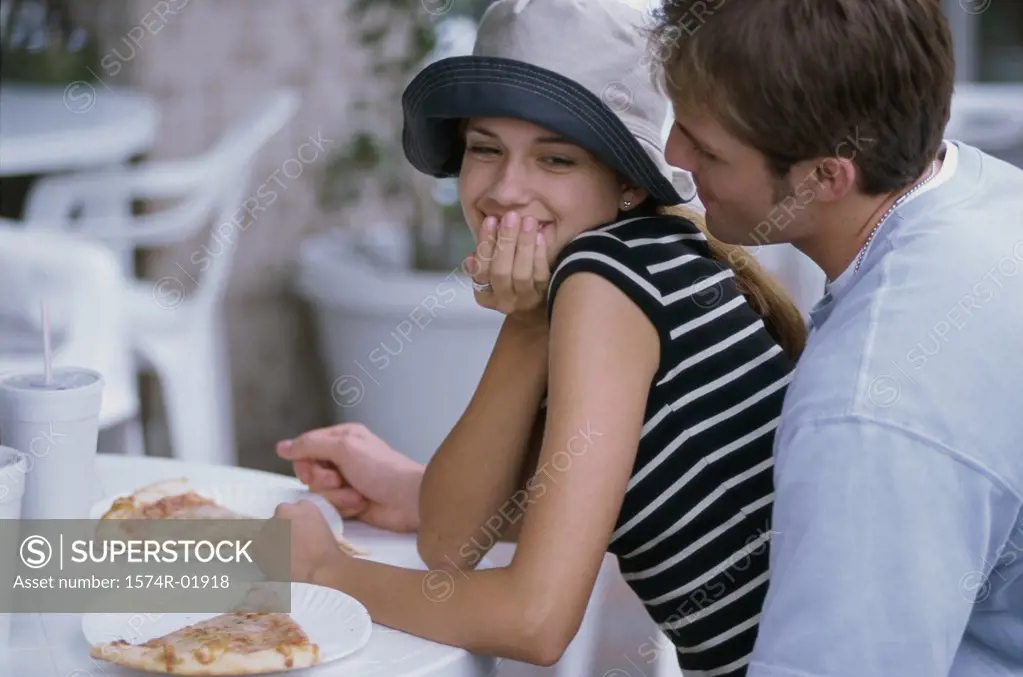 Young couple sitting at a table outdoors