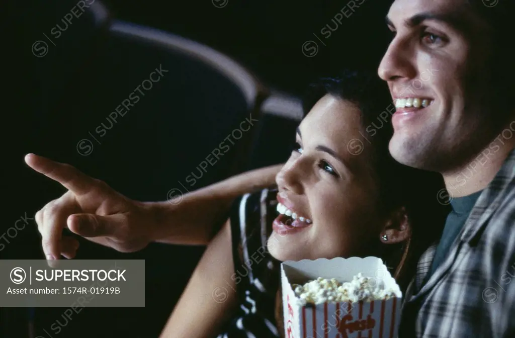 Close-up of a young couple watching a movie in a theater