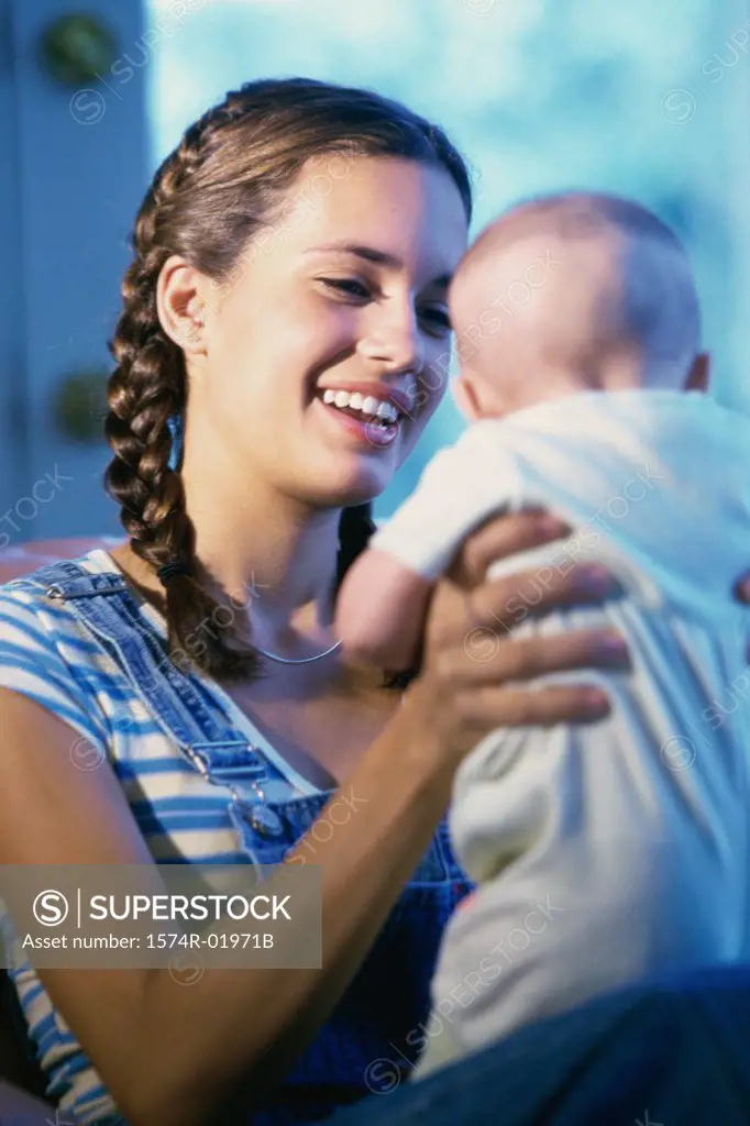Teenage girl holding a baby