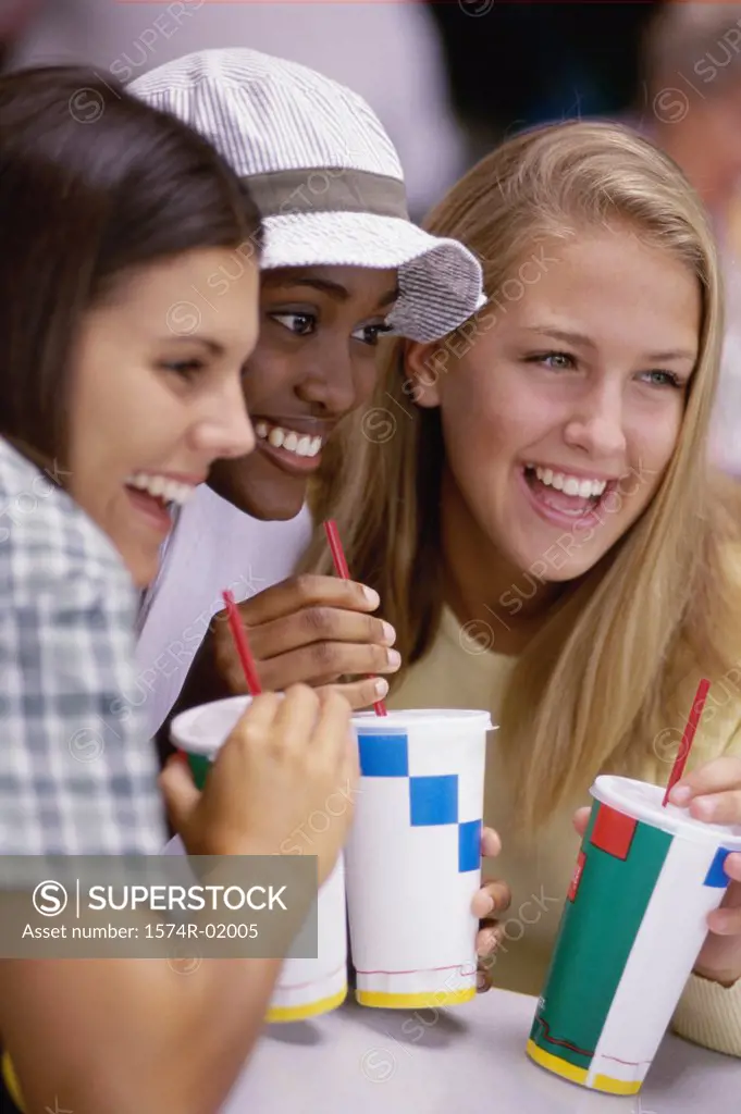 Close-up of three teenage girls smiling