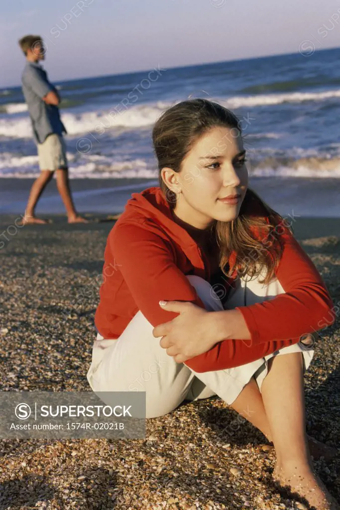 Teenage girl sitting at the beach