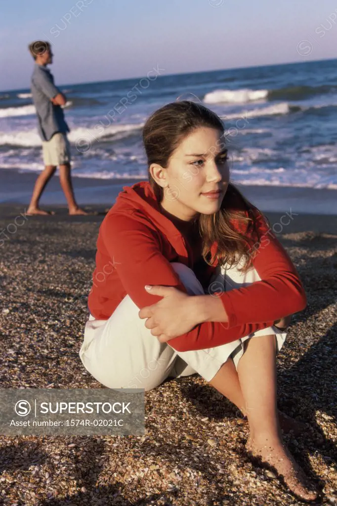 Teenage girl sitting at the beach