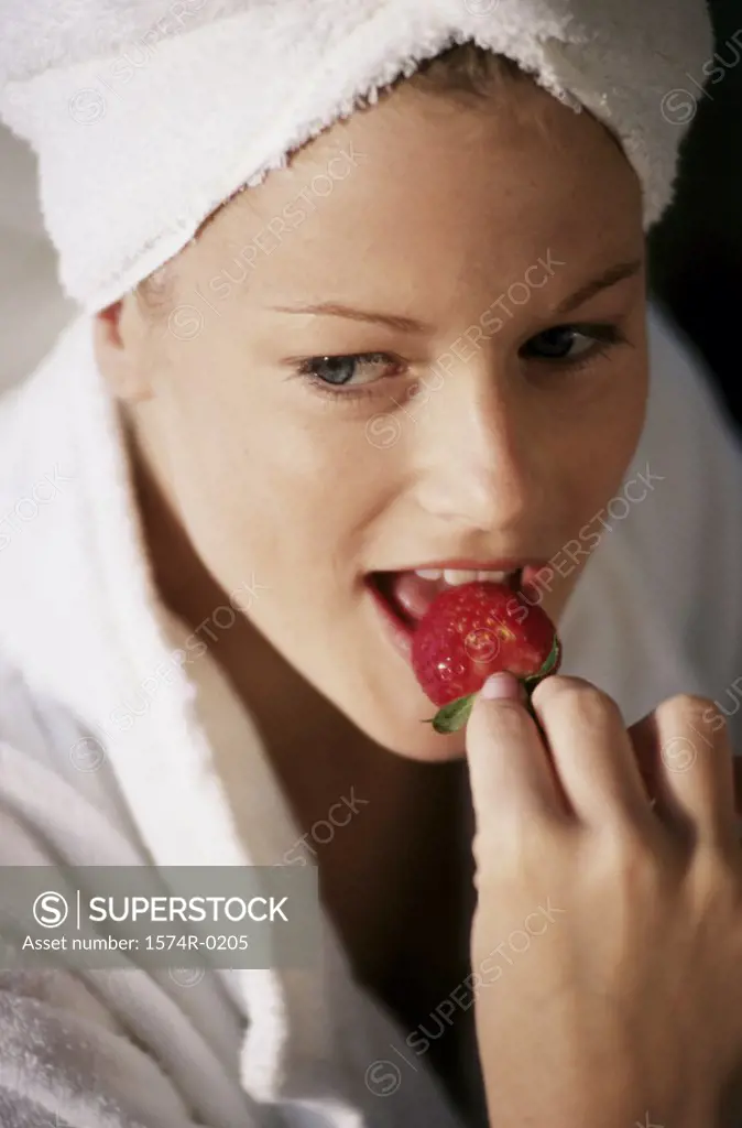 Young woman eating a strawberry