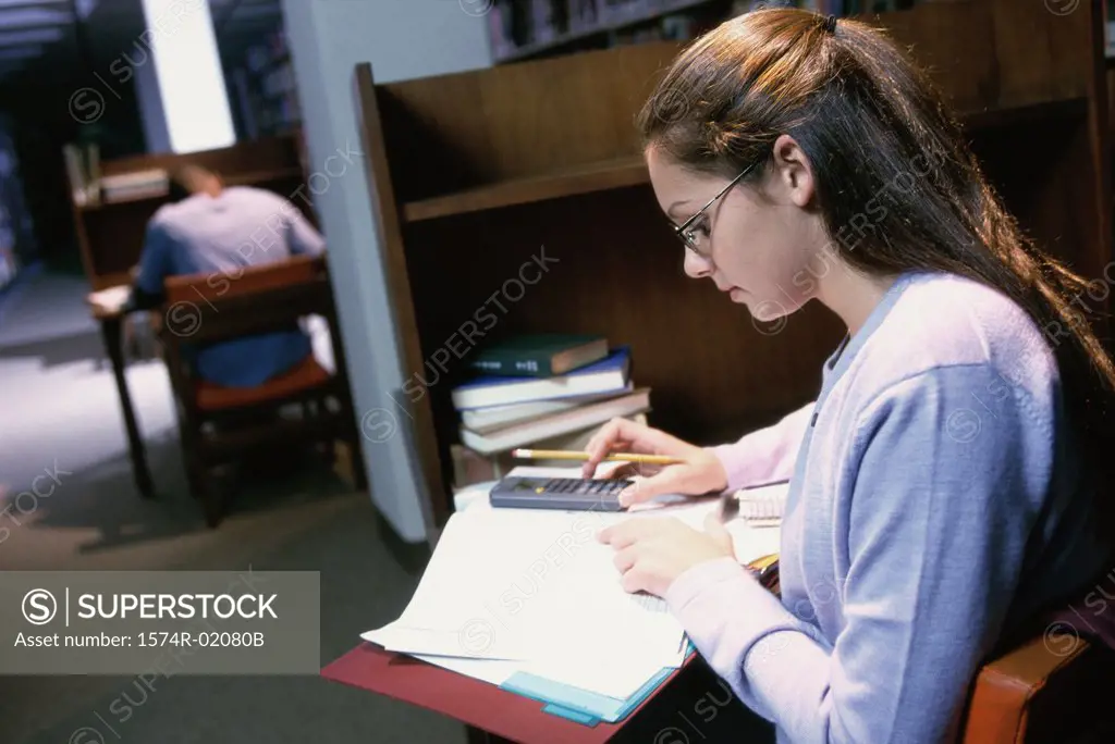 Teenage girl studying in a library