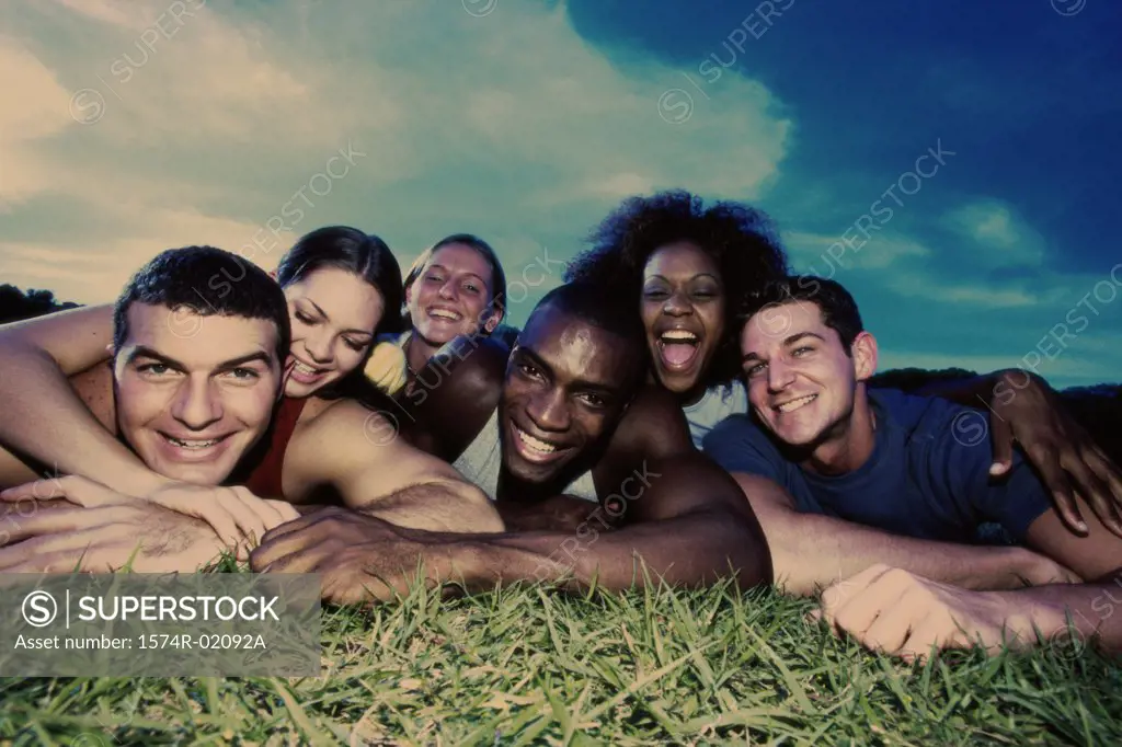 Portrait of a group of young people lying on grass