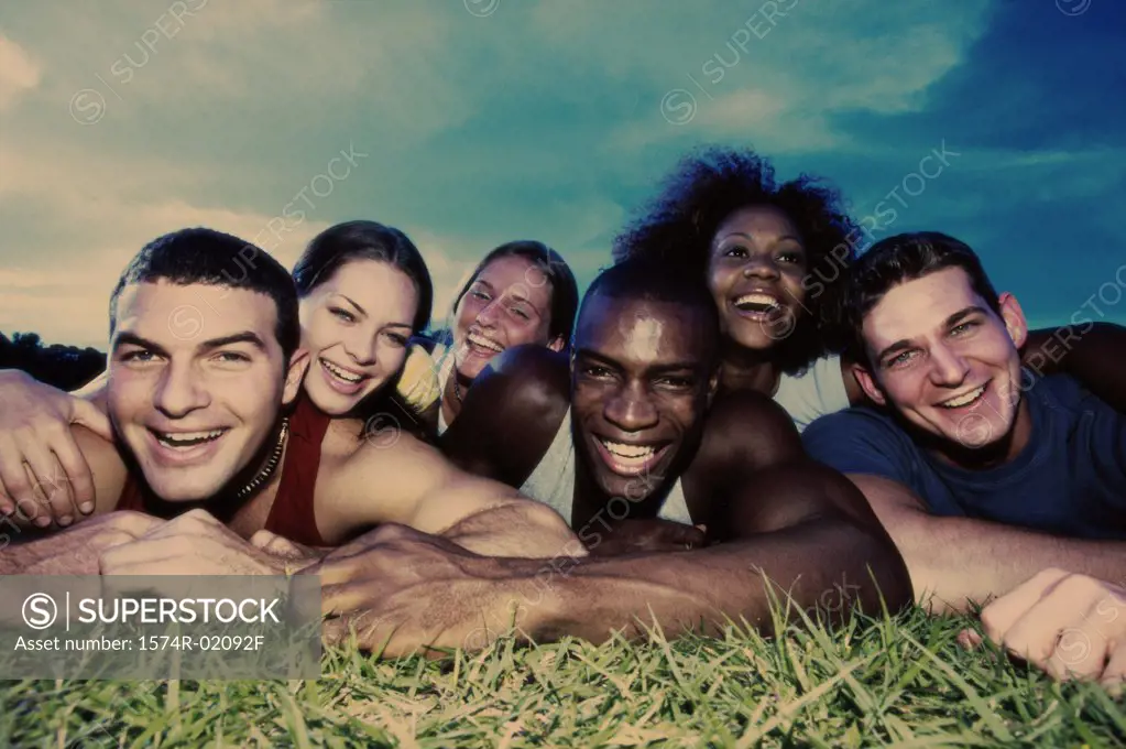 Portrait of a group of young people lying on grass