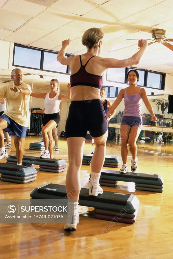 Group of people exercising in a step aerobics class
