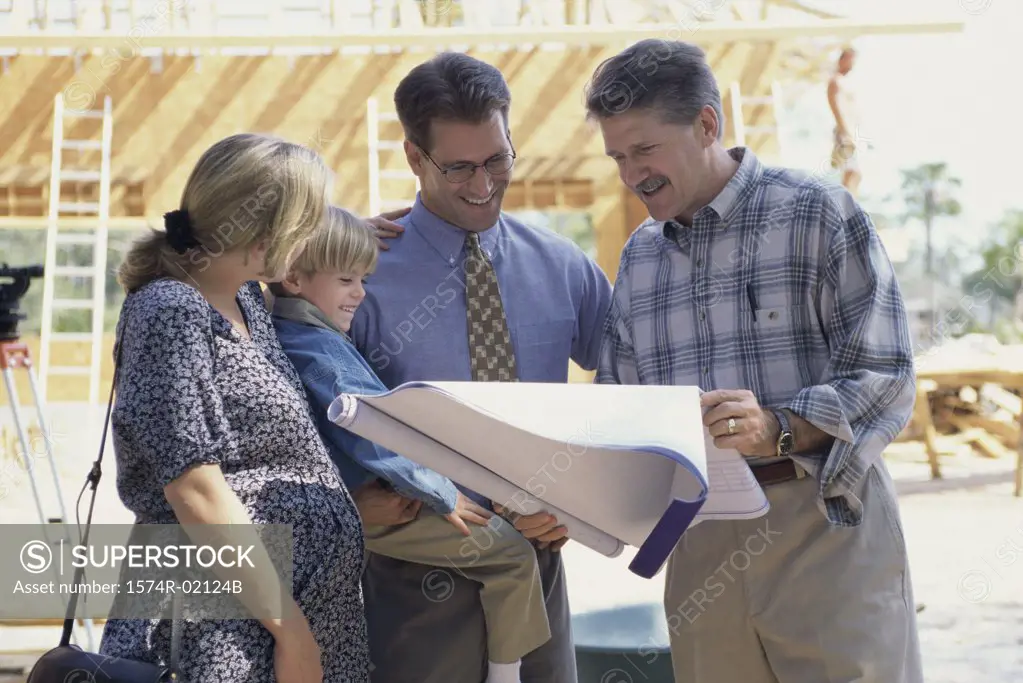Architect discussing blueprints with a family