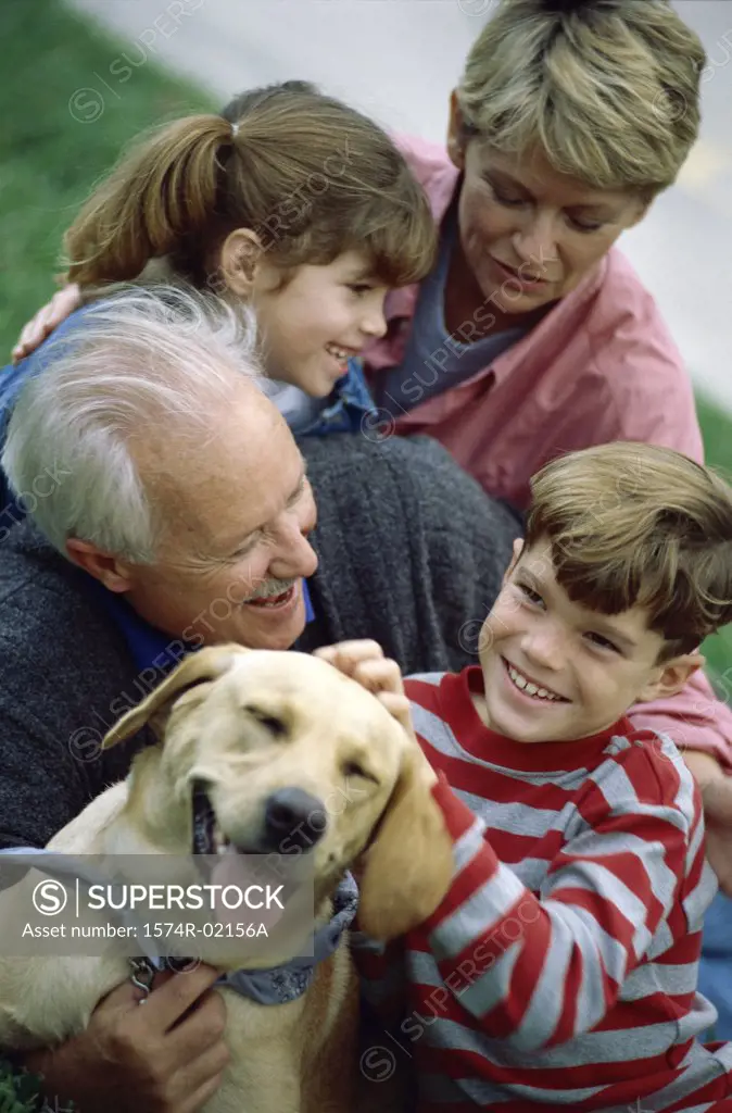 Grandparents with their grandson and granddaughter holding their dog