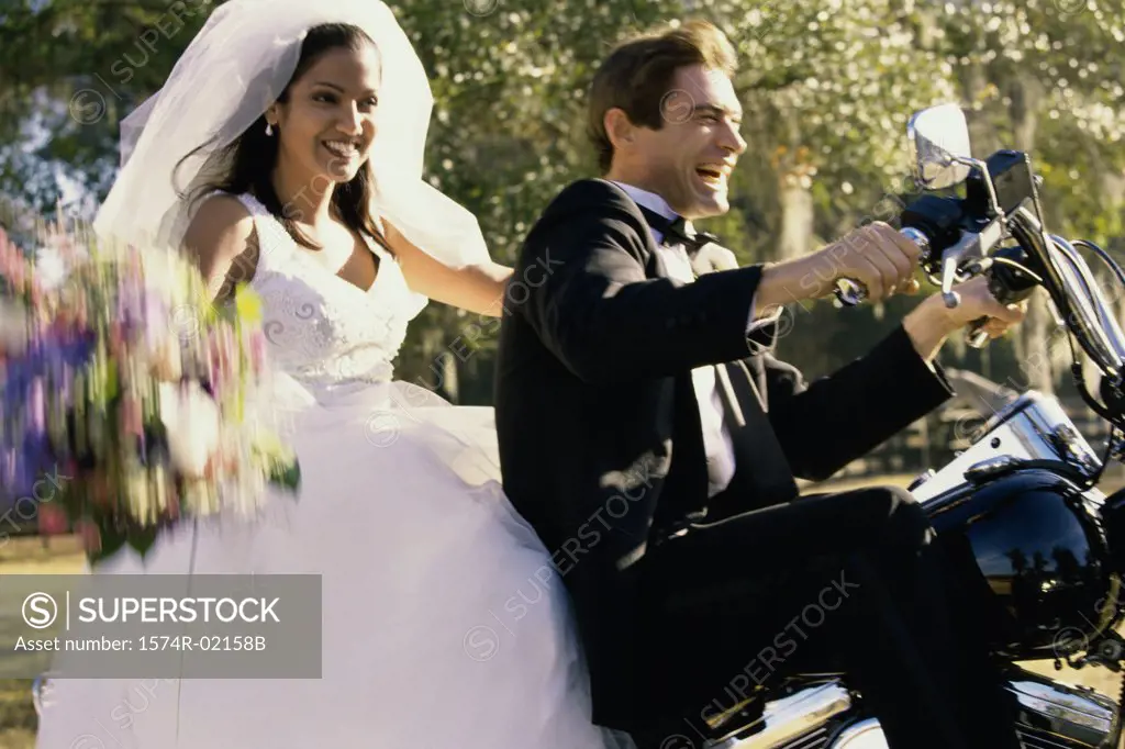 Newlywed couple riding on a motorcycle