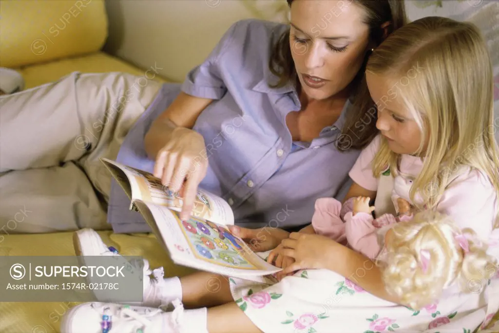 Mother reading a book with her daughter