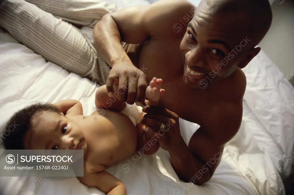 Portrait of a father holding his baby boy's feet