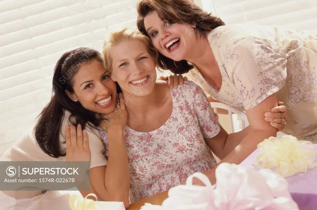 Portrait of three young women smiling at a baby shower