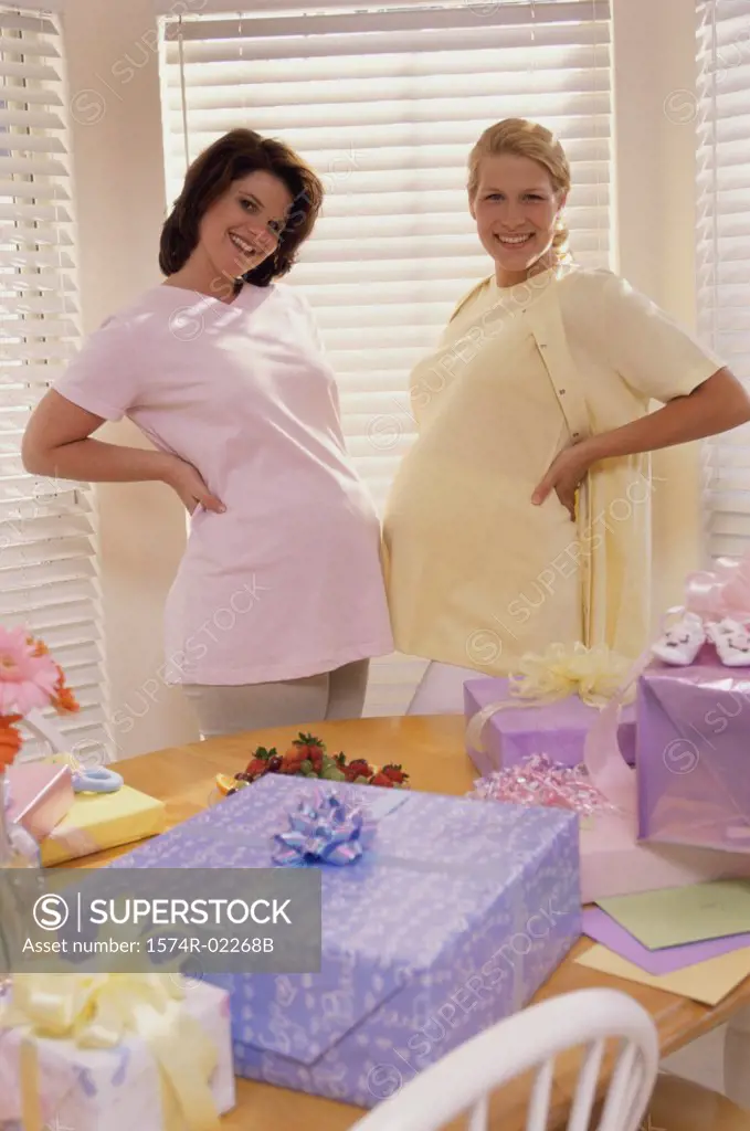 Portrait of two pregnant women standing at a baby shower
