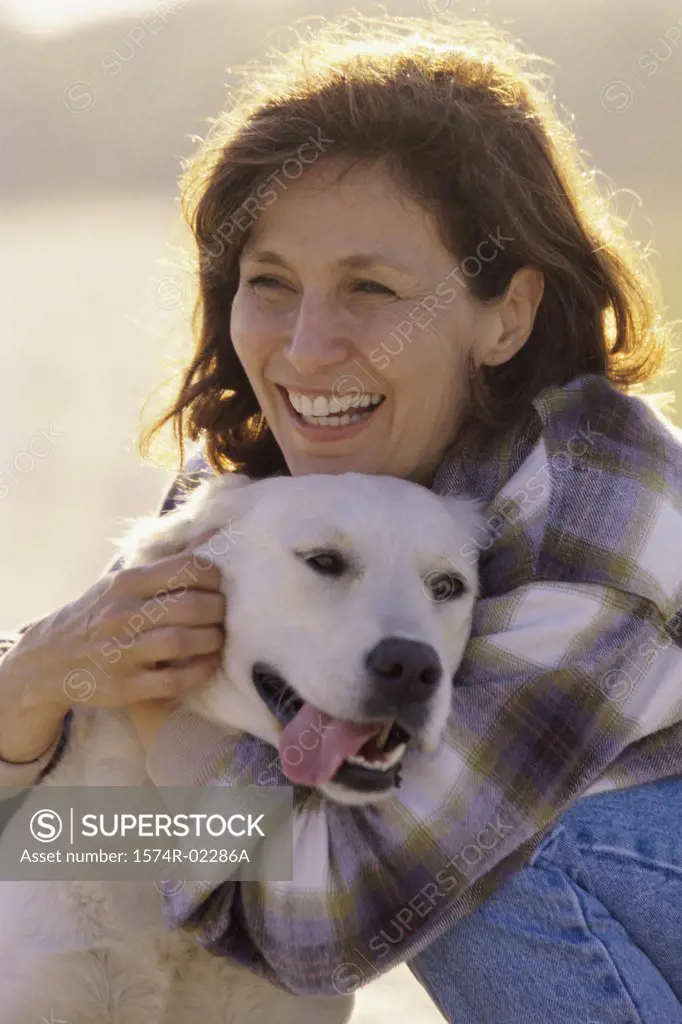 Mid adult woman hugging her dog