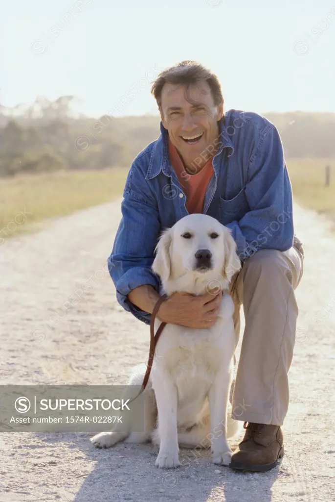 Portrait of a mature man holding his dog