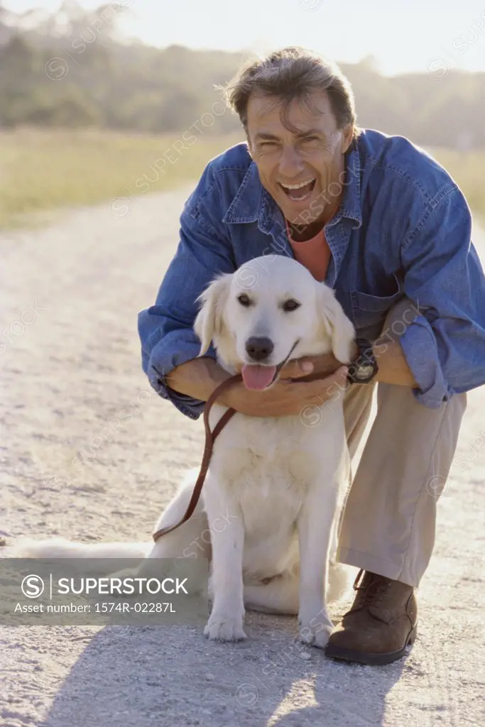 Portrait of a mature man holding his dog