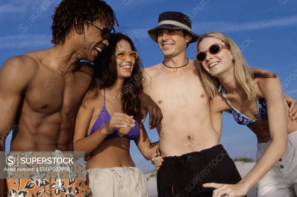 Two teenage couples on the beach