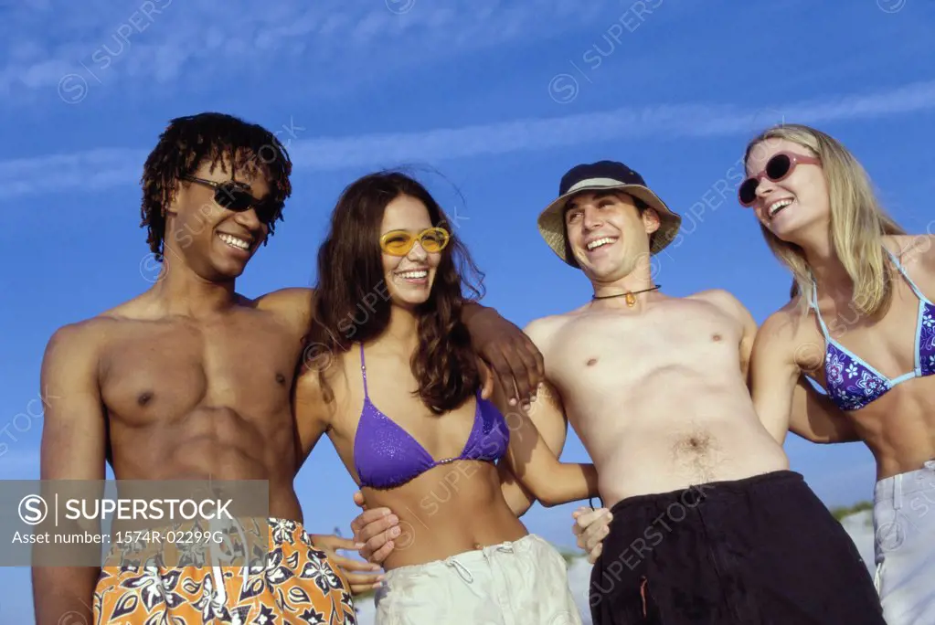 Two teenage couples on the beach