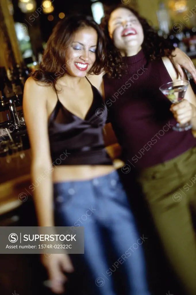 Two young women drinking in a bar