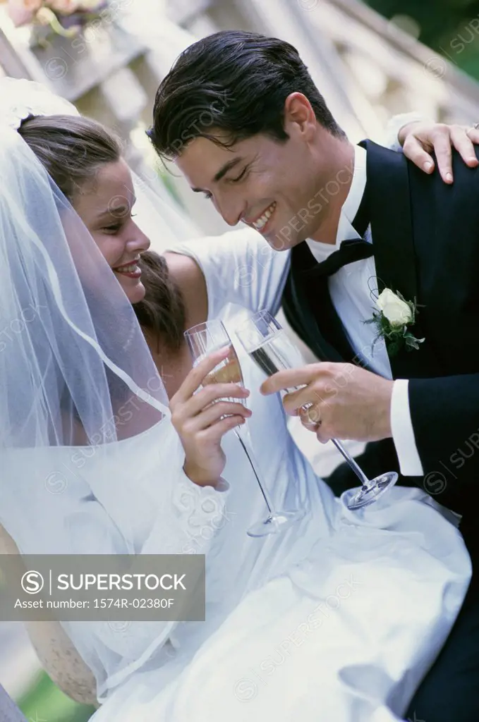 Newlywed couple toasting with glasses of champagne