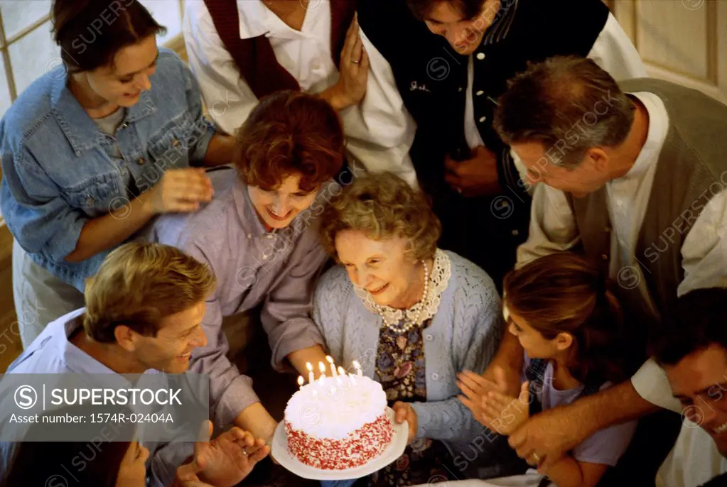 High angle view of a family in front of a birthday cake