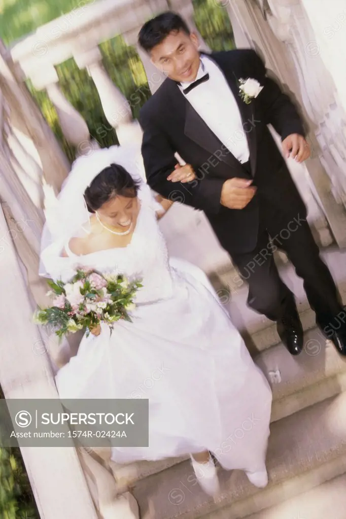 High angle view of a newlywed couple walking down stairs