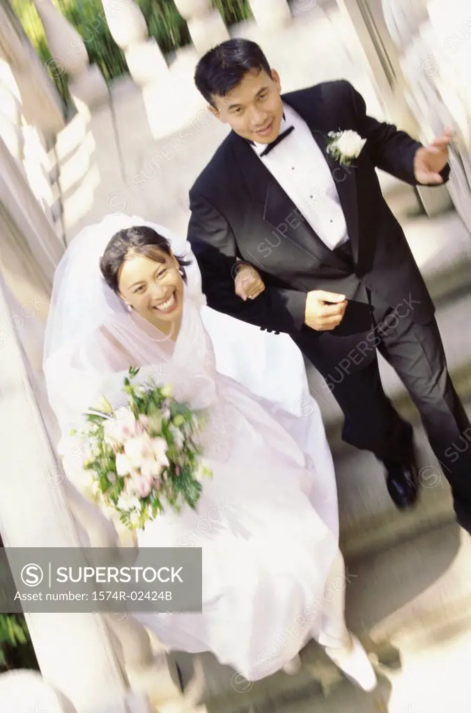 High angle view of a newlywed couple walking down stairs