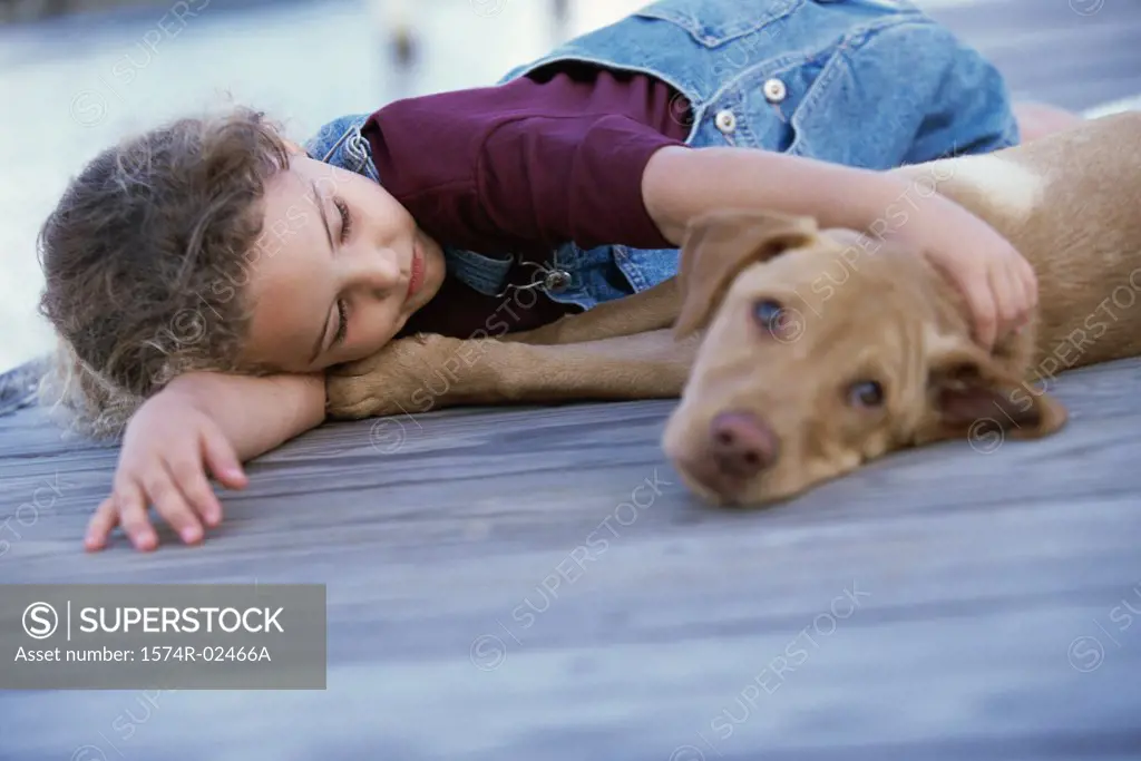 Girl lying down with her dog