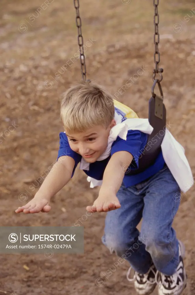 High angle view of a boy hanging on a swing