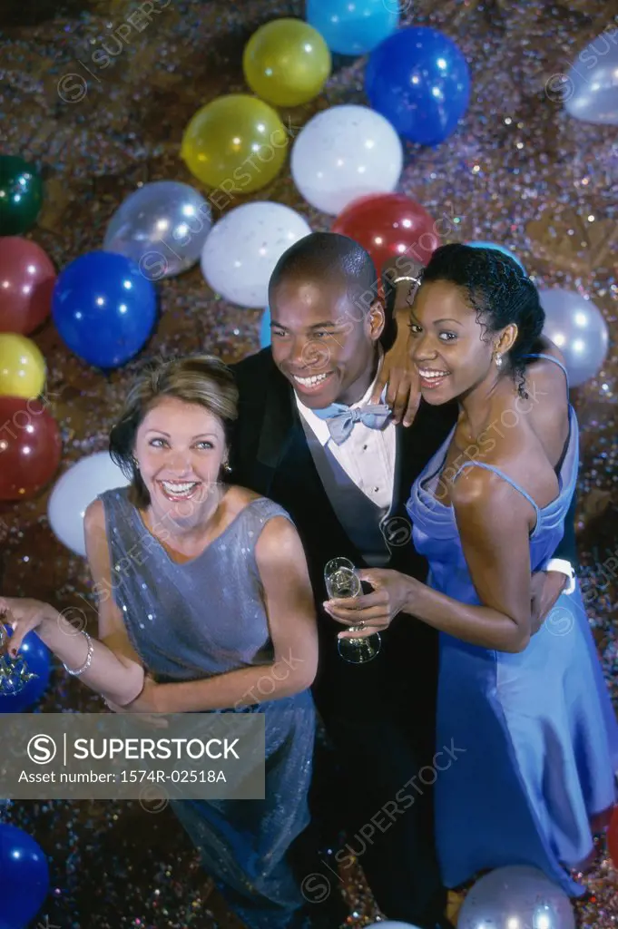 High angle view of two young women with a young man at a party