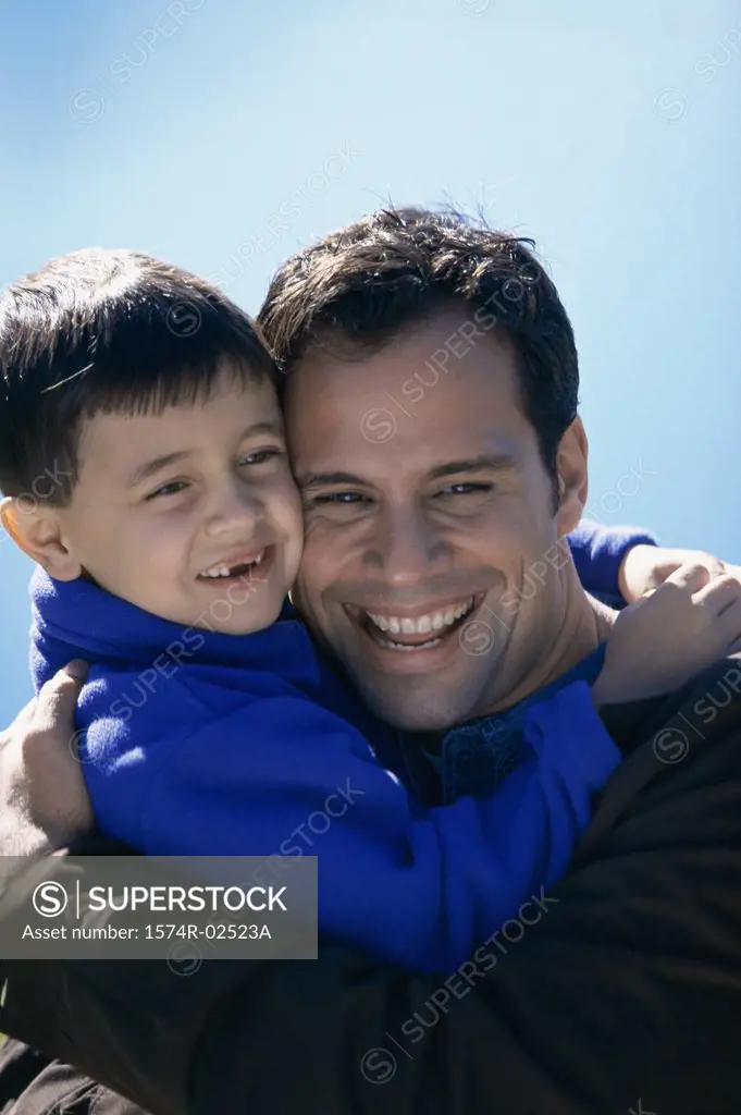 Close-up of a father hugging his son