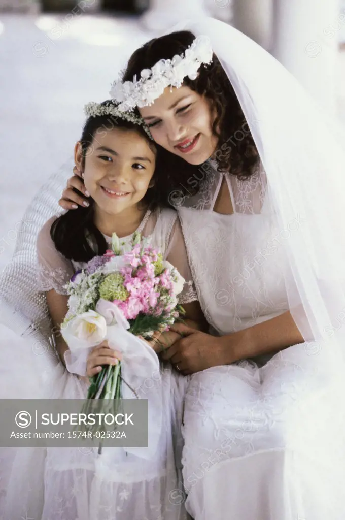 Bride smiling with a flower girl