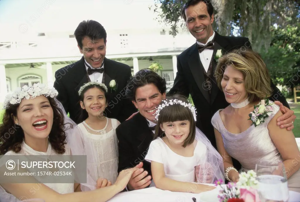 Portrait of wedding guests with a newlywed couple