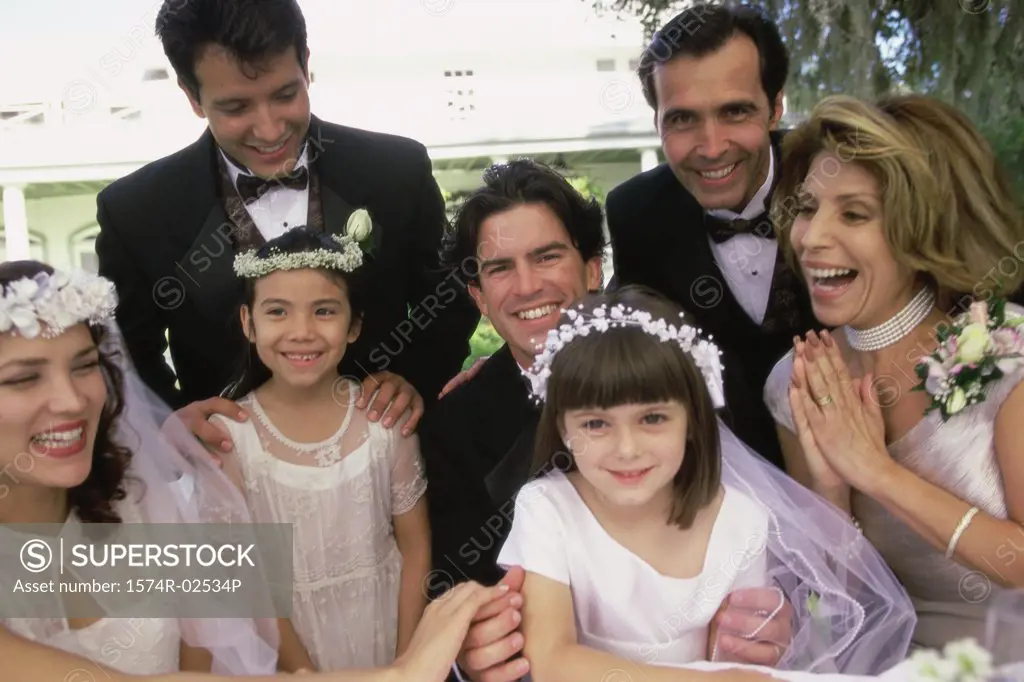 Portrait of wedding guests with a newlywed couple