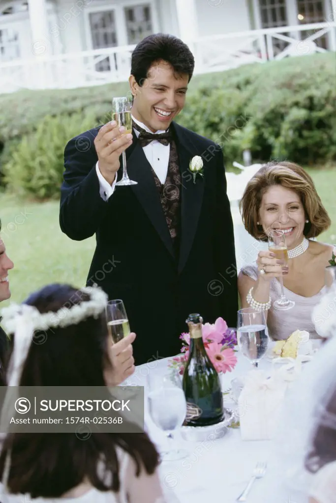 Group of people at a wedding toasting with glasses of champagne