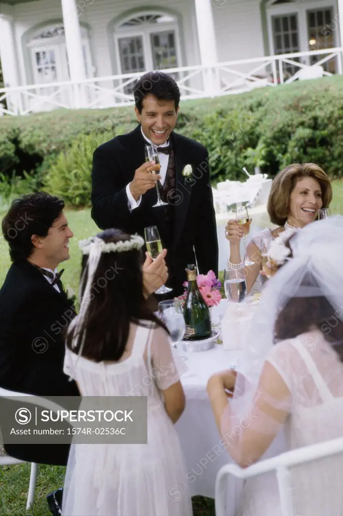 Group of people at a wedding toasting with glasses of champagne