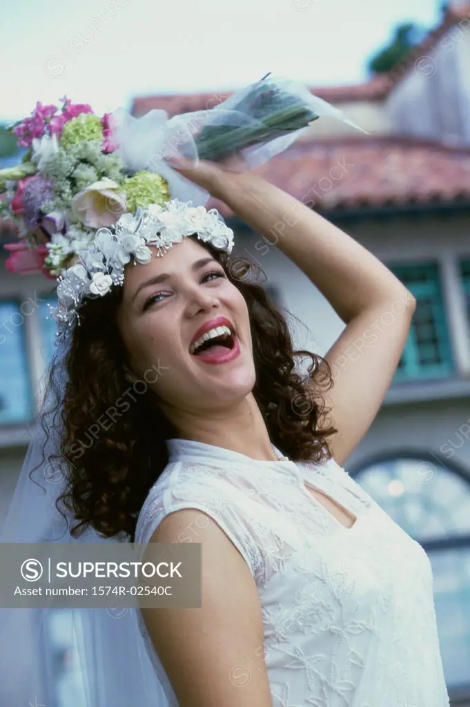 Newlywed young woman preparing to toss the bouquet